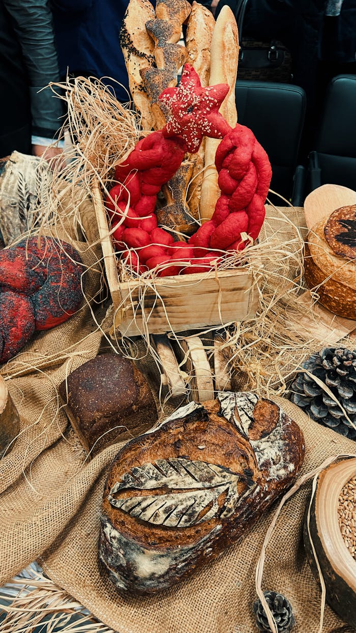 Rustic display of artisanal bread with decorative elements and woven textures.